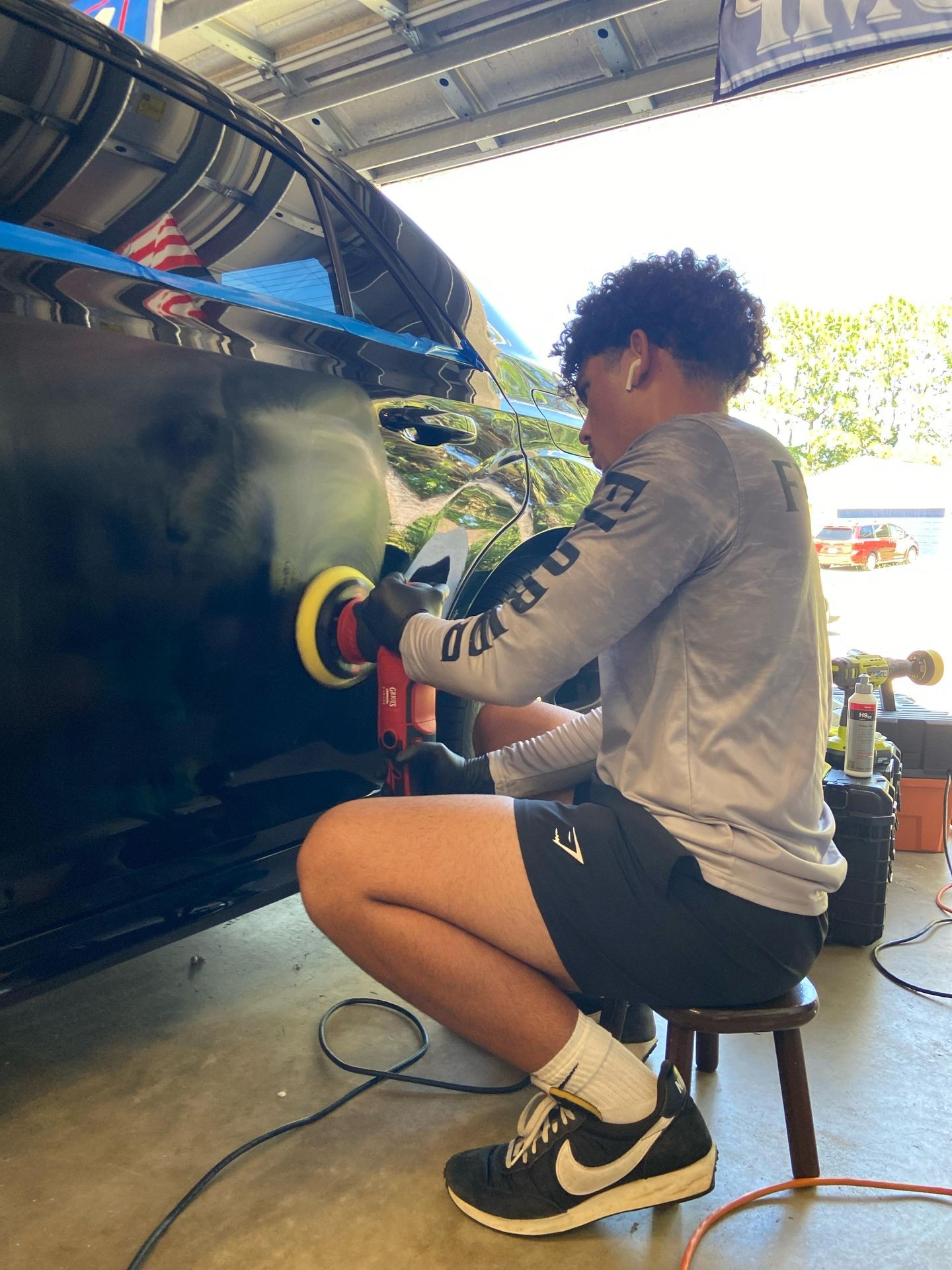 Doing a 2 Step Paint Correction on a black luxury car located in Palm Coast